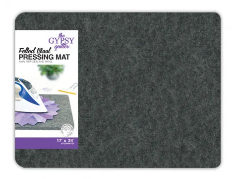 A gray felted wool pressing mat with a label showing an iron on a quilt block.
