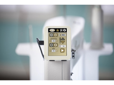 A close-up shows the digital display of a Baby Lock Regent quilting machine.
