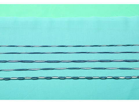 Five rows of decorative blue and white serger stitches on a teal fabric swatch.