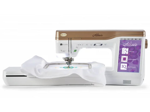 A white and gold Baby Lock Altair sewing and embroidery machine with fabric in a hoop.