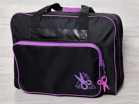Black sewing machine tote bag with purple accents and a scissor logo.