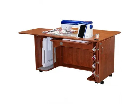 A brown sewing and embroidery cabinet with a blue and white sewing machine on top.