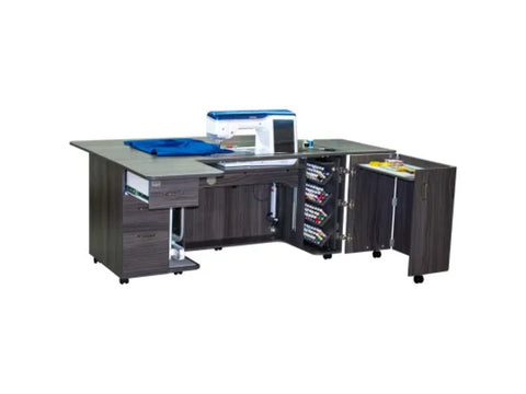 A dark wood sewing cabinet with a sewing machine, blue fabric, and open storage for thread and tools.