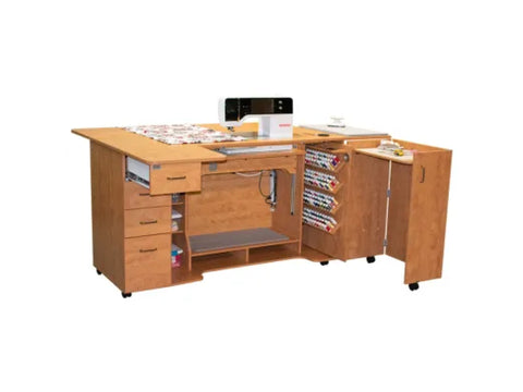 A tall, light wood sewing cabinet with a sewing machine, thread storage, and drawers.