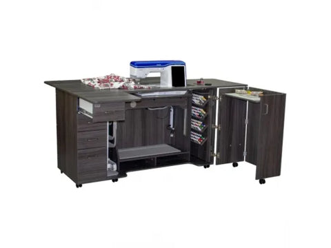 Dark gray sewing cabinet with a sewing machine, fabric, and thread spools.