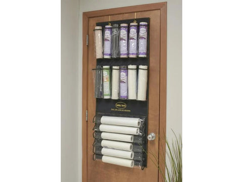 Baby Lock Over The Door Stabilizer Organizer hanging on a wooden door.