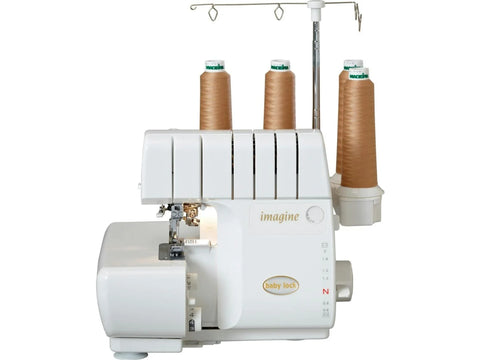 A white Baby Lock Imagine 2 serger with three spools of brown thread.