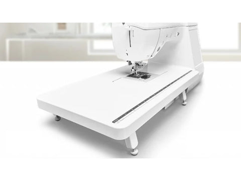 White Baby Lock sewing machine with an attached extension table.