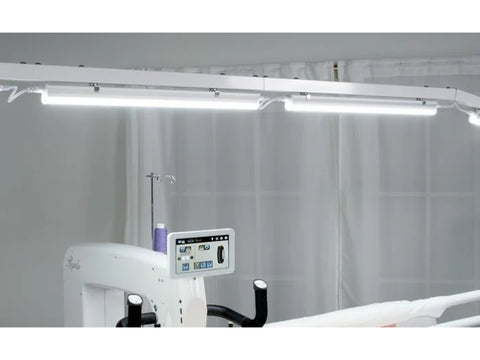 A 10-foot light bar illuminates a quilting machine and frame.