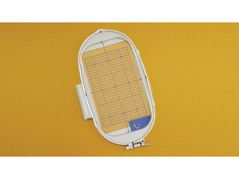 Embroidery hoop with a grid insert, measuring 6 1/4" x 10 1/4".