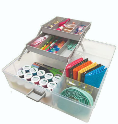 A clear, multi-tiered storage box filled with sewing notions, fabric, and thread.