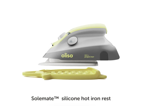 Pistachio green and gray Oliso M3Pro Project Iron with a matching silicone hot iron rest.