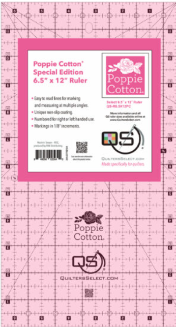 A pink 6.5 by 12 inch quilting ruler with white markings and a Poppie Cotton label.