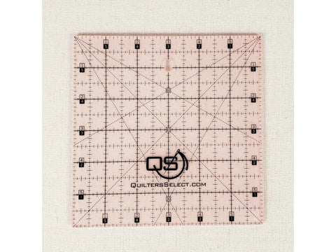 A pink 6x6 inch Quilters Select non-slip quilting ruler with black markings.