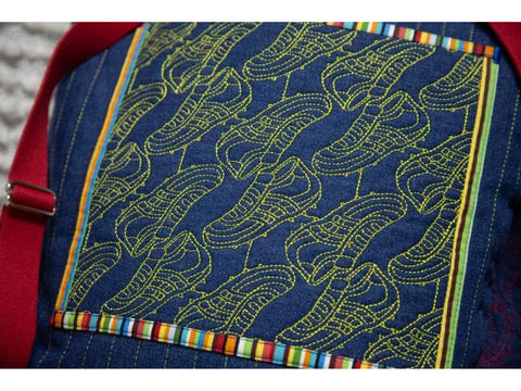 A blue denim bag features yellow embroidered sports shoe motifs and colorful striped trim.