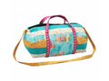 A colorful quilted weekender bag with a city skyline and geometric patterns.