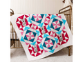 A colorful quilt with geometric patterns and koala appliques draped over a crib.