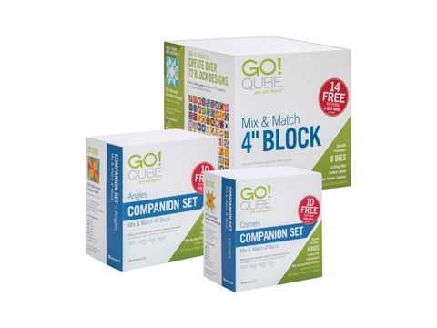 Three white boxes of AccuQuilt Qube quilting sets are stacked on a white background.