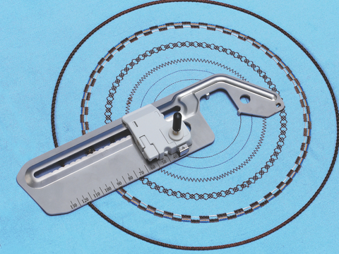 A Baby Lock Circular Stitch Attachment on blue fabric with various circular stitch patterns.