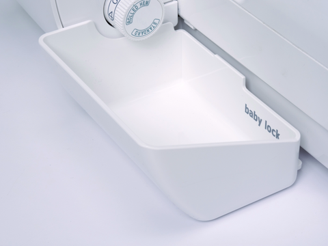 White Baby Lock Deluxe Serger Trim Bin with "baby lock" printed on the side.
