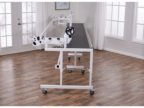 A white Baby Lock Regalia long arm quilting machine with a 12-foot Maestro frame.