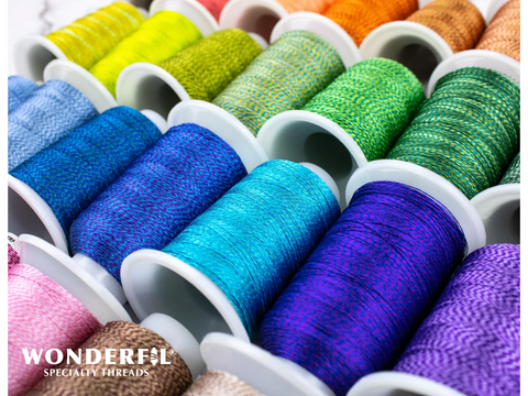 A close-up of multiple spools of colorful, dual-color D-Twist thread.