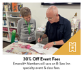 A man signs a book for a smiling woman in a sewing store.