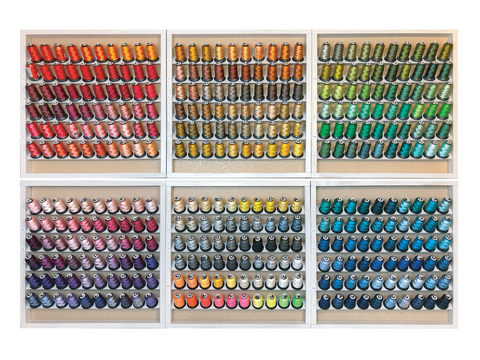 A large collection of 360 spools of Floriani embroidery thread in various colors.