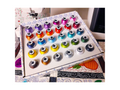 A box of 30 Floriani embroidery thread spools in various bold colors.