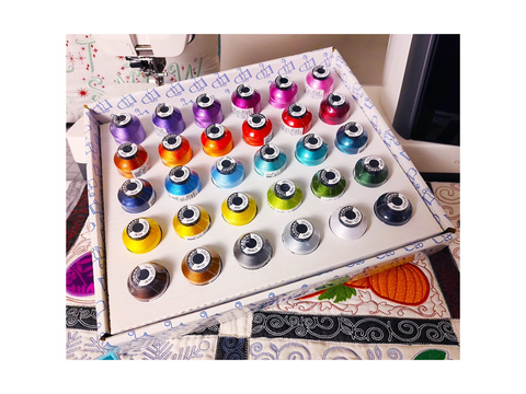 A box of 30 Floriani embroidery thread spools in various bold colors.