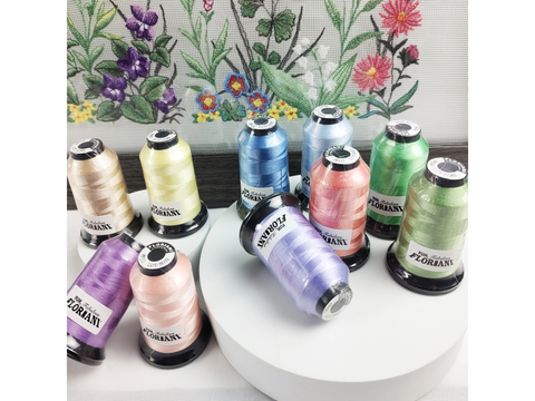 A collection of Floriani embroidery thread spools in various pastel colors.