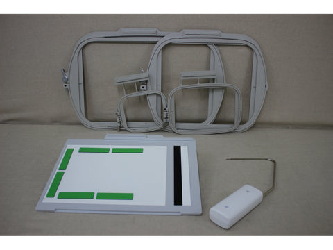 A set of light gray embroidery hoops, a white and gray fabric placement tool, and a white stylus.