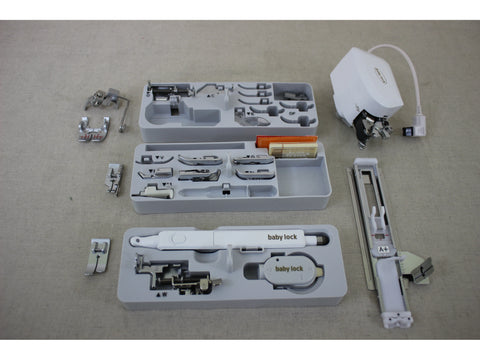 A collection of Baby Lock sewing machine accessories and attachments in various trays.