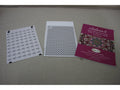 Three white and pink documents for the Baby Lock Solaris 2 sewing machine are on a gray surface.