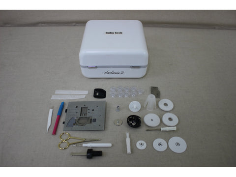 A white Baby Lock Solaris 2 sewing machine case with various accessories laid out.