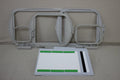 Four embroidery hoops and a white and green placement mat are on a light gray surface.
