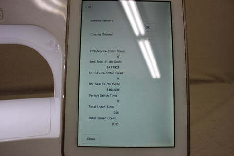 A pre-owned Baby Lock Solaris sewing and embroidery machine displays its usage statistics on screen.