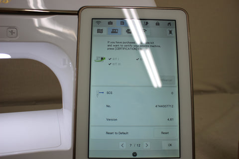 A Baby Lock Solaris sewing and embroidery machine displays its digital screen with upgrade information.