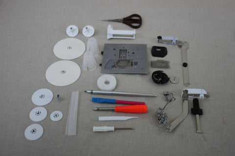 A collection of sewing machine accessories, including bobbins, presser feet, and tools.