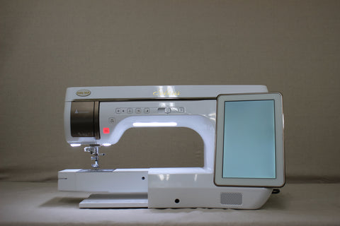 A white Baby Lock Solaris sewing and embroidery machine with a large touchscreen.