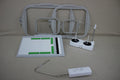 Various sewing and embroidery machine accessories are displayed on a light brown surface.