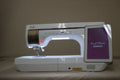 A white Baby Lock Solaris 2 sewing and embroidery machine with a lit screen.