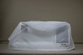 A Baby Lock Solaris 2 sewing and embroidery machine is covered by a translucent white dust cover.