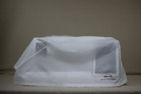 A Baby Lock Solaris 2 sewing and embroidery machine is covered by a translucent white dust cover.