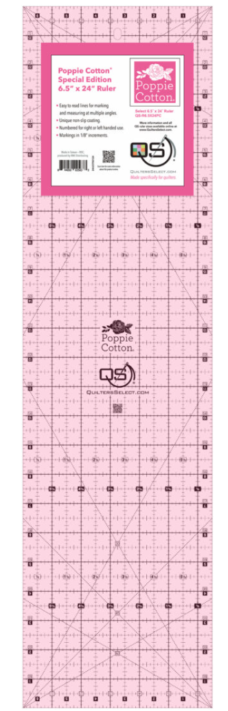 A pink Quilters Select 6.5 by 24 inch ruler with Poppie Cotton branding.
