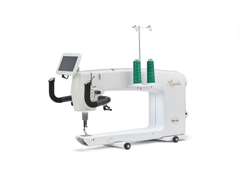 A white Baby Lock Regalia long arm quilting machine with two spools of green thread.