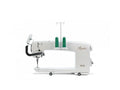 A white Baby Lock Regalia 20-inch long arm machine with two green spools of thread.