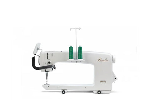 A white Baby Lock Regalia 20-inch long arm machine with two green spools of thread.