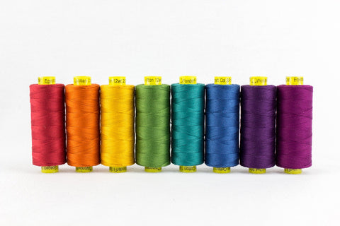 Nine spools of Wonderfil 12wt thread in a rainbow of jewel tones.