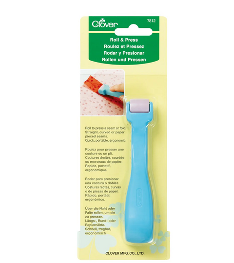 A blue Clover Roll & Press tool with a purple roller is packaged for sale.